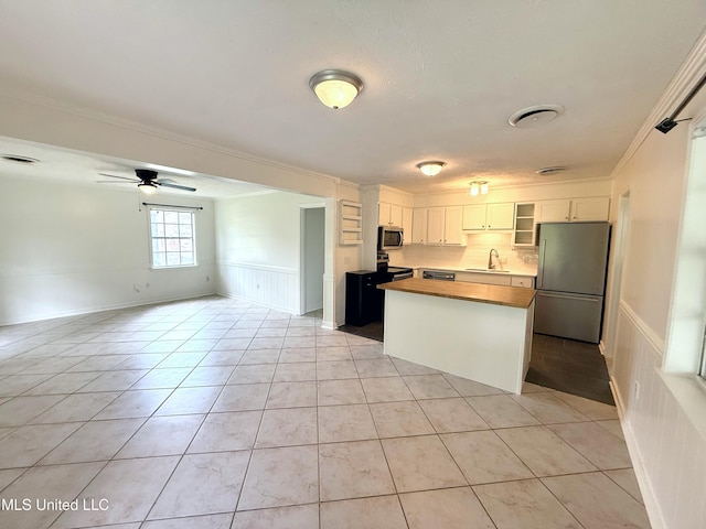 239 Traceland Dr, Madison, MS 39110 - kitchen with appliances with stainless steel finishes, a sink, wooden counters, crown molding, and open floor plan