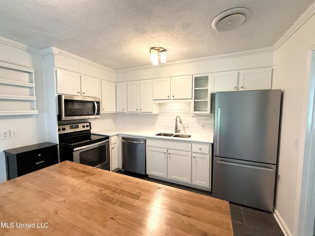 239 Traceland Dr, Madison, MS 39110 - kitchen featuring stainless steel appliances, a sink, wood counters, crown molding, and white cabinets