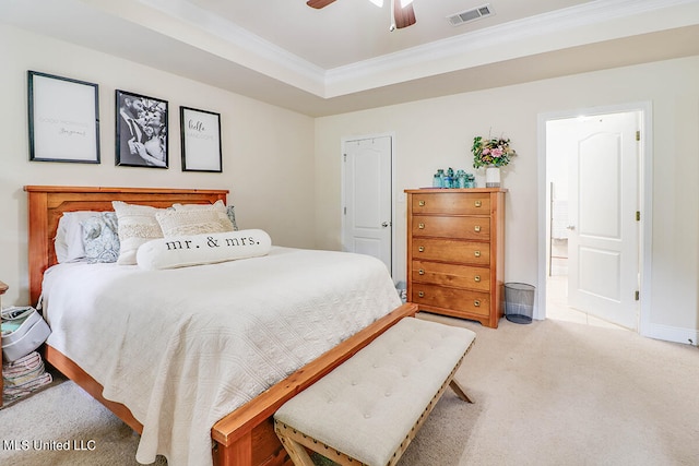 carpeted bedroom with ornamental molding, a raised ceiling, and ceiling fan