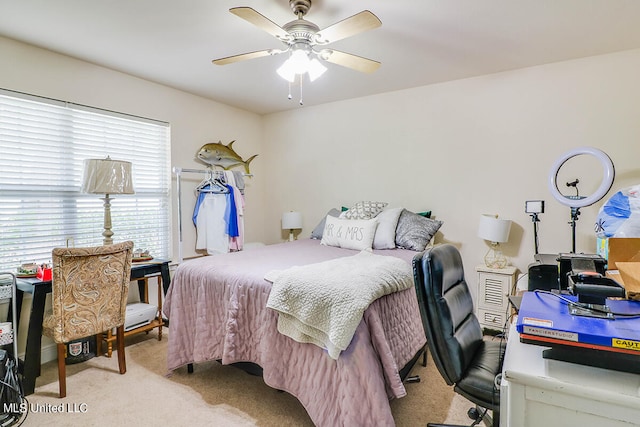 bedroom with light colored carpet and ceiling fan