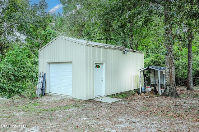 garage featuring wooden walls