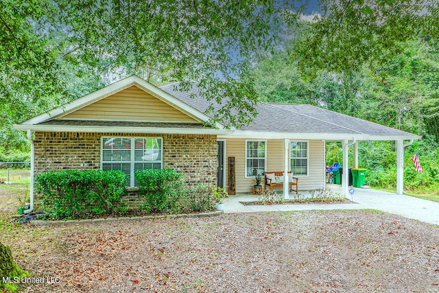 ranch-style home with a porch and a carport