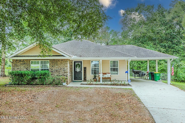 ranch-style house featuring a porch and a carport