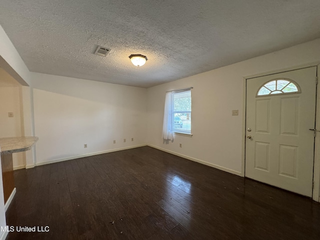 foyer featuring dark hardwood / wood-style floors and a textured ceiling