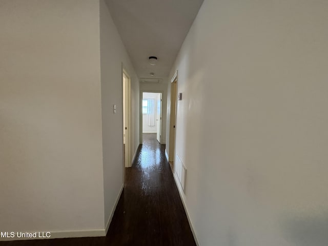 corridor featuring dark hardwood / wood-style floors