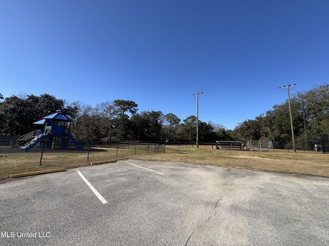 view of parking / parking lot featuring a playground