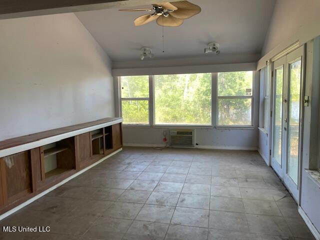interior space featuring a wall unit AC and french doors
