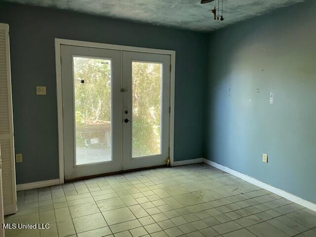doorway to outside featuring light tile patterned floors, french doors, and baseboards