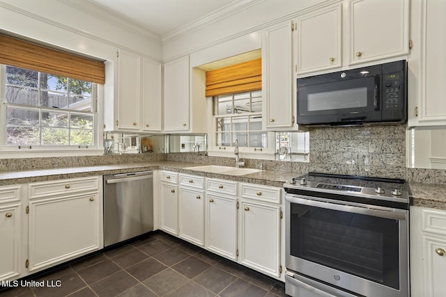 kitchen with tasteful backsplash, crown molding, tile counters, appliances with stainless steel finishes, and a sink