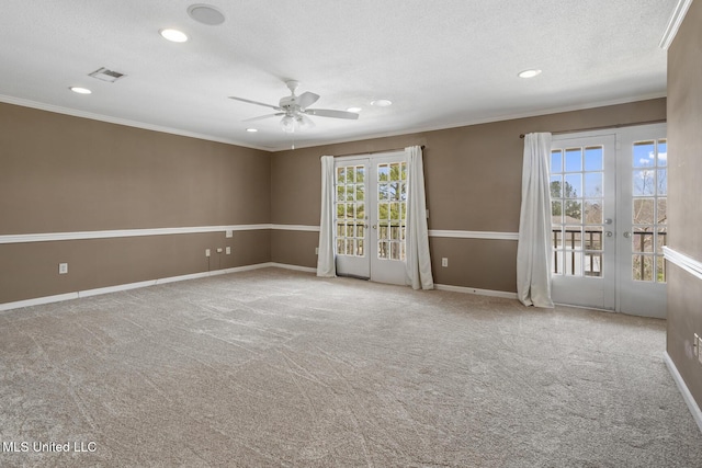 empty room featuring a ceiling fan, crown molding, french doors, and a textured ceiling