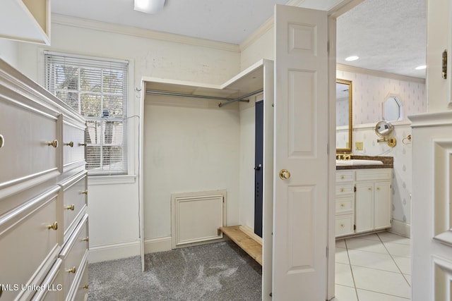 spacious closet featuring light tile patterned floors and light carpet