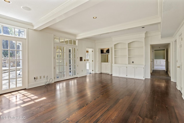 unfurnished living room with beamed ceiling, built in shelves, dark wood-style floors, french doors, and crown molding