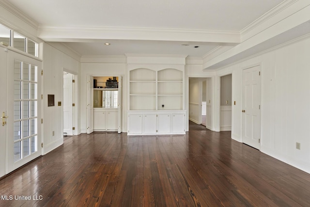 unfurnished room with built in shelves, dark wood finished floors, and ornamental molding