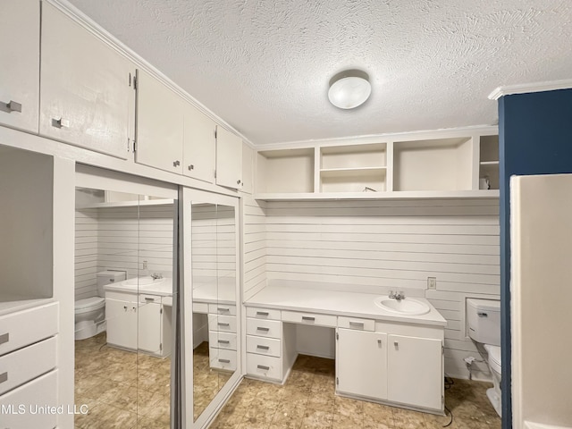 office featuring a textured ceiling and a sink