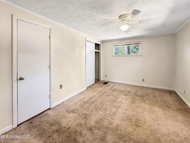 unfurnished bedroom with a closet, carpet, and a textured ceiling