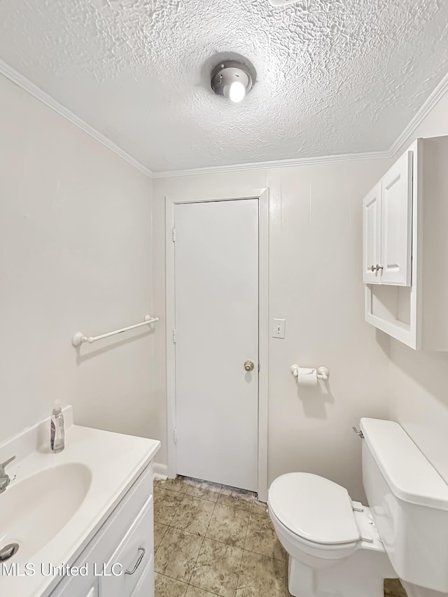 half bathroom with toilet, vanity, and a textured ceiling