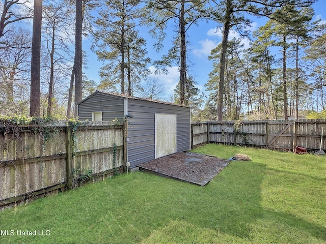 view of yard featuring an outdoor structure, a storage shed, and a fenced backyard