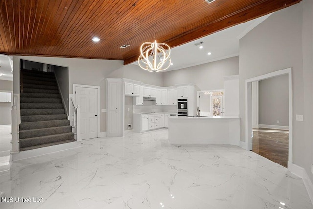 interior space with white cabinets, an inviting chandelier, high vaulted ceiling, wooden ceiling, and double oven