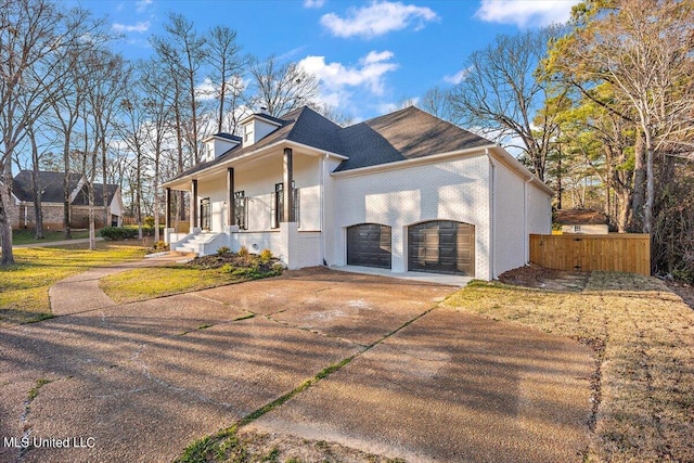 view of side of property with a yard and covered porch