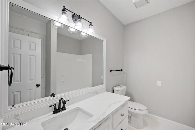 bathroom with vanity, toilet, and tile patterned flooring