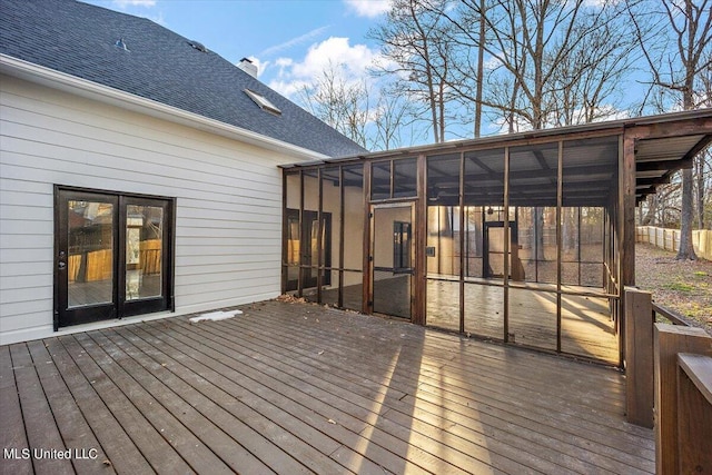 wooden deck with a sunroom