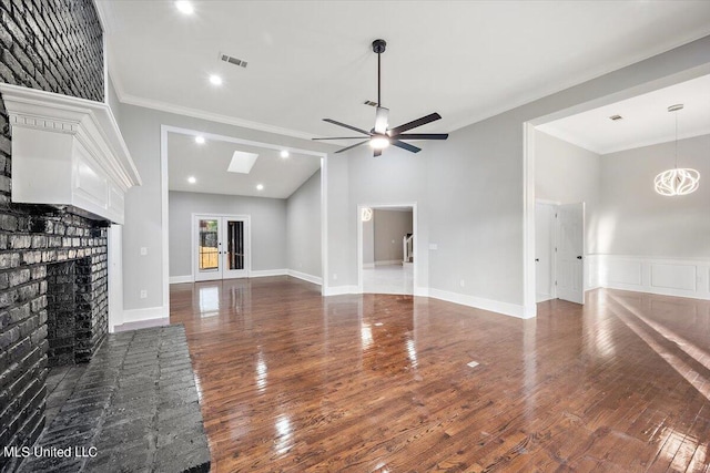 unfurnished living room with dark wood-type flooring, crown molding, and ceiling fan