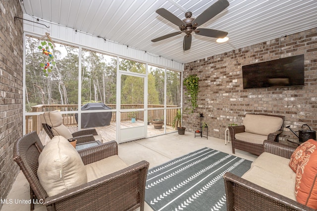 sunroom featuring ceiling fan and a healthy amount of sunlight