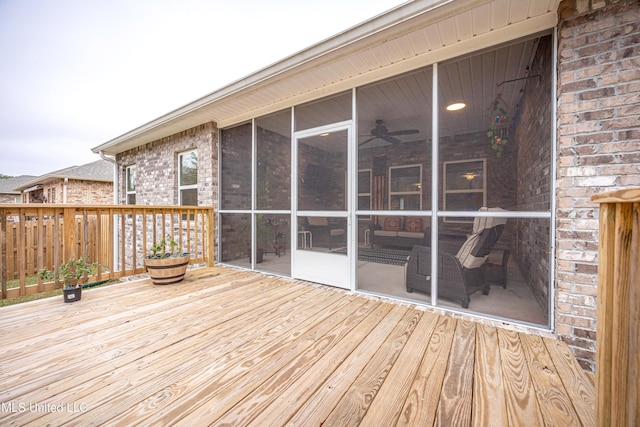 wooden deck featuring a sunroom