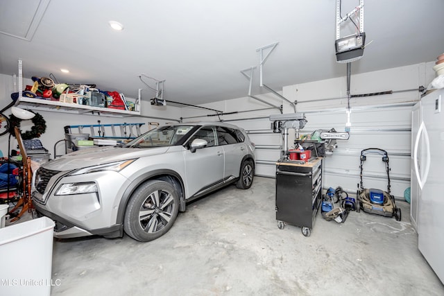 garage with white fridge and a garage door opener