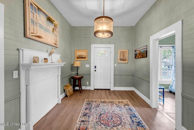 foyer featuring baseboards and wood finished floors