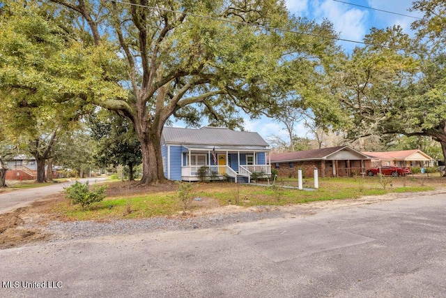 view of front of home featuring covered porch and metal roof