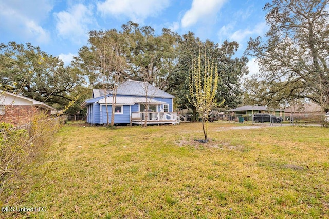 view of yard with fence and a wooden deck