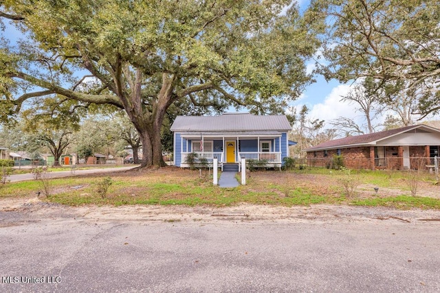 bungalow-style house with metal roof and a porch