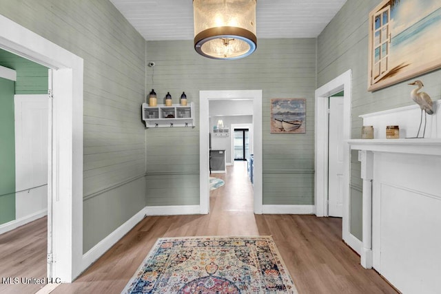 hall featuring baseboards and wood finished floors