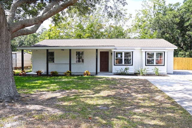 ranch-style house with covered porch and a front lawn