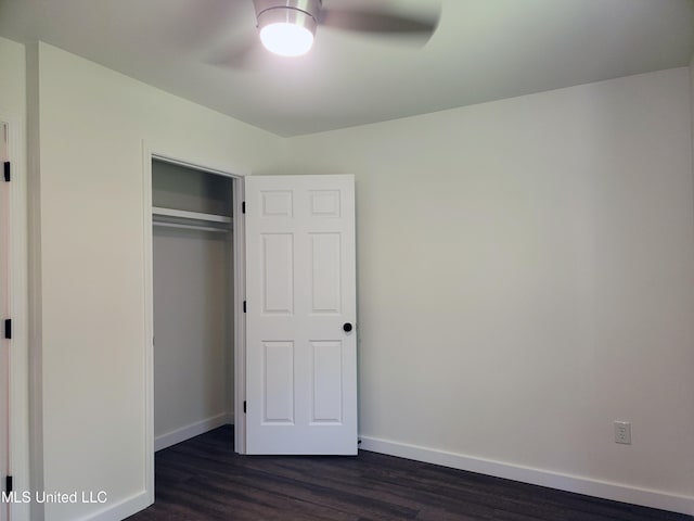 unfurnished bedroom featuring a closet, ceiling fan, and dark hardwood / wood-style flooring