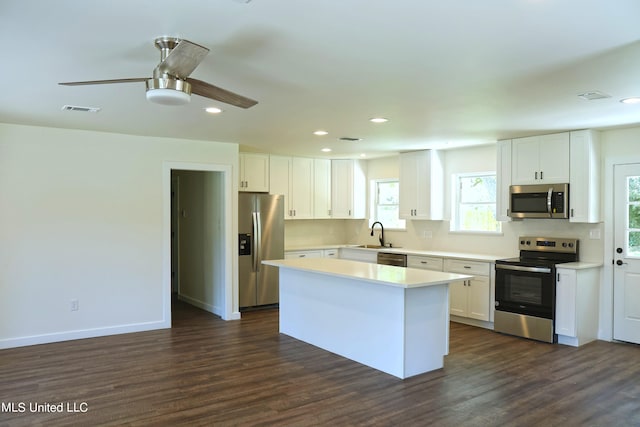 kitchen featuring white cabinetry, stainless steel appliances, and dark hardwood / wood-style flooring