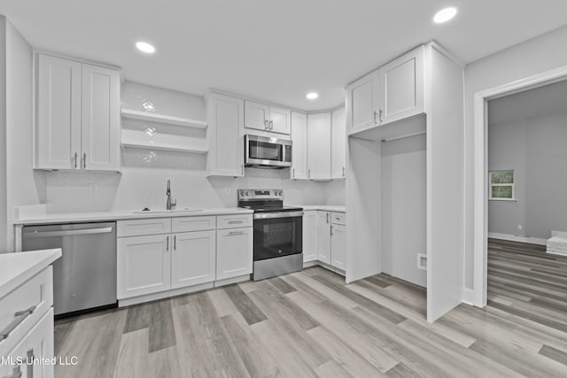 kitchen featuring white cabinets, appliances with stainless steel finishes, and sink