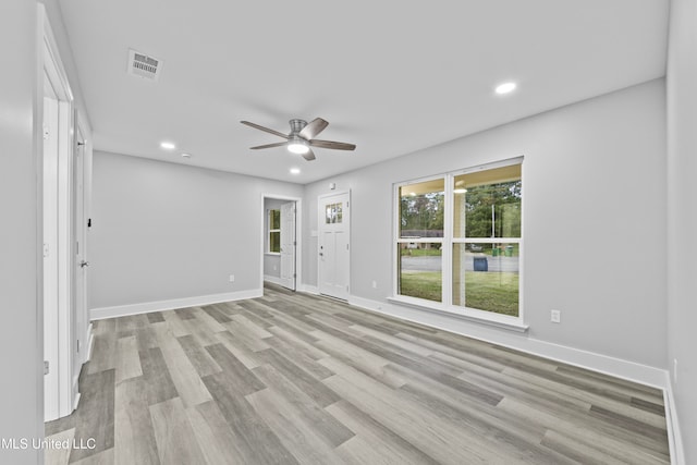 empty room featuring ceiling fan and light hardwood / wood-style floors