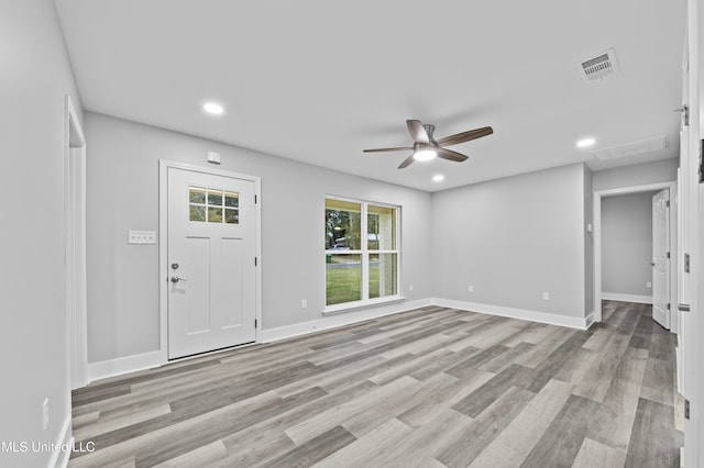 entrance foyer with ceiling fan and light hardwood / wood-style flooring