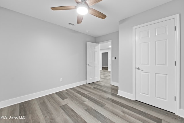 unfurnished bedroom with light hardwood / wood-style flooring and ceiling fan