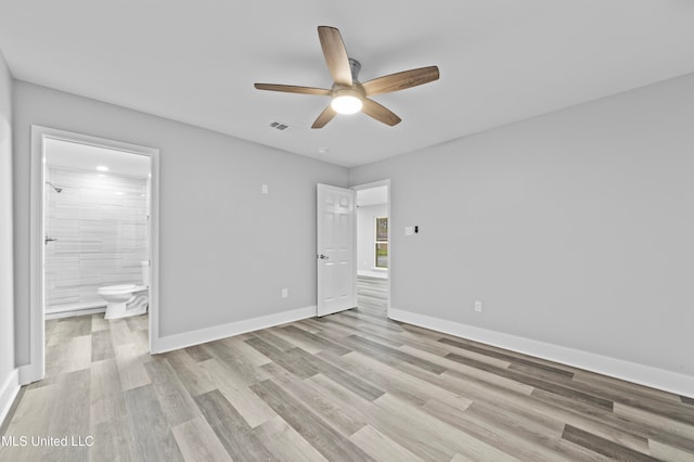 unfurnished bedroom with connected bathroom, ceiling fan, and light wood-type flooring