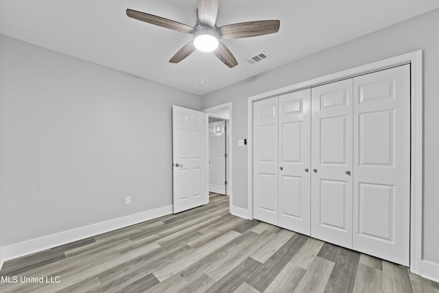 unfurnished bedroom with a closet, ceiling fan, and light hardwood / wood-style flooring