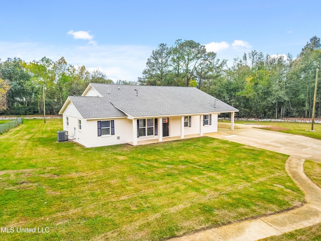 rear view of house with a lawn, a carport, and central air condition unit