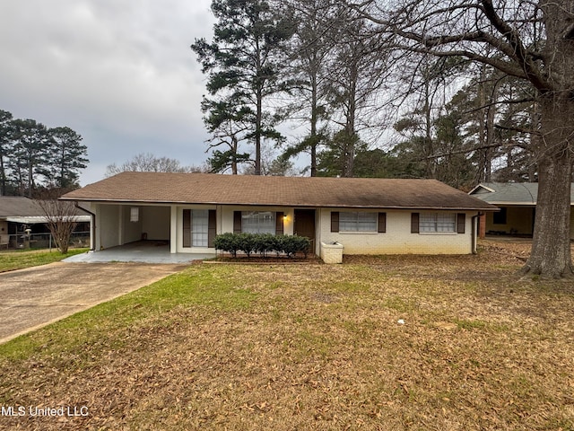 single story home featuring driveway, brick siding, a carport, and a front yard