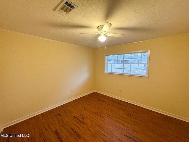 unfurnished room featuring baseboards, a textured ceiling, visible vents, and dark wood-style flooring