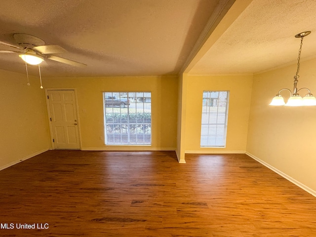 spare room featuring a wealth of natural light, a textured ceiling, and wood finished floors