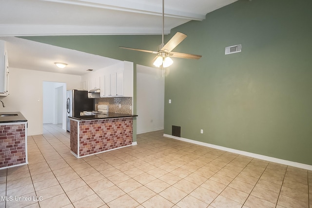 kitchen featuring sink, ceiling fan, stove, vaulted ceiling with beams, and white cabinets