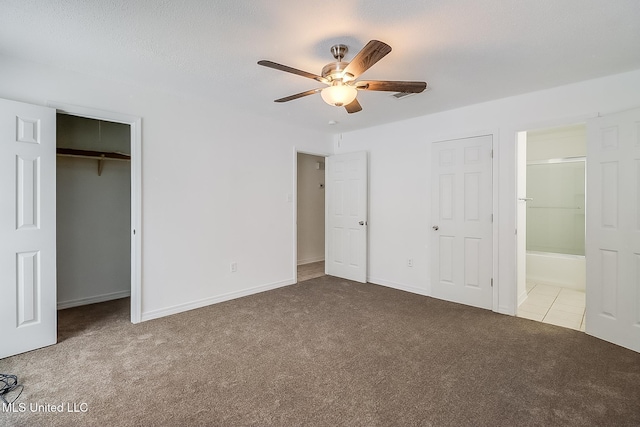 unfurnished bedroom featuring light carpet, ceiling fan, and ensuite bathroom
