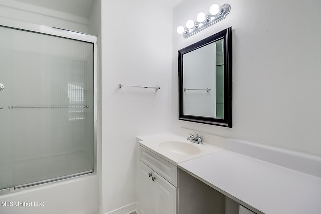 bathroom with vanity and combined bath / shower with glass door